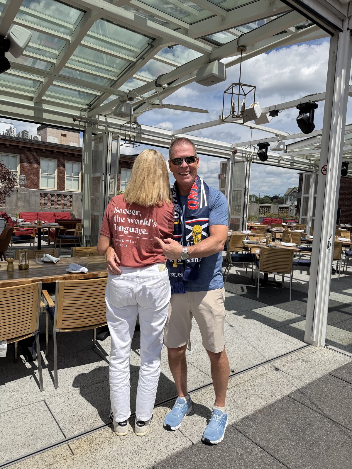Fan wearing the Soccer, the world's language fitted tee